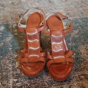 Frye brand leather and wood heels.